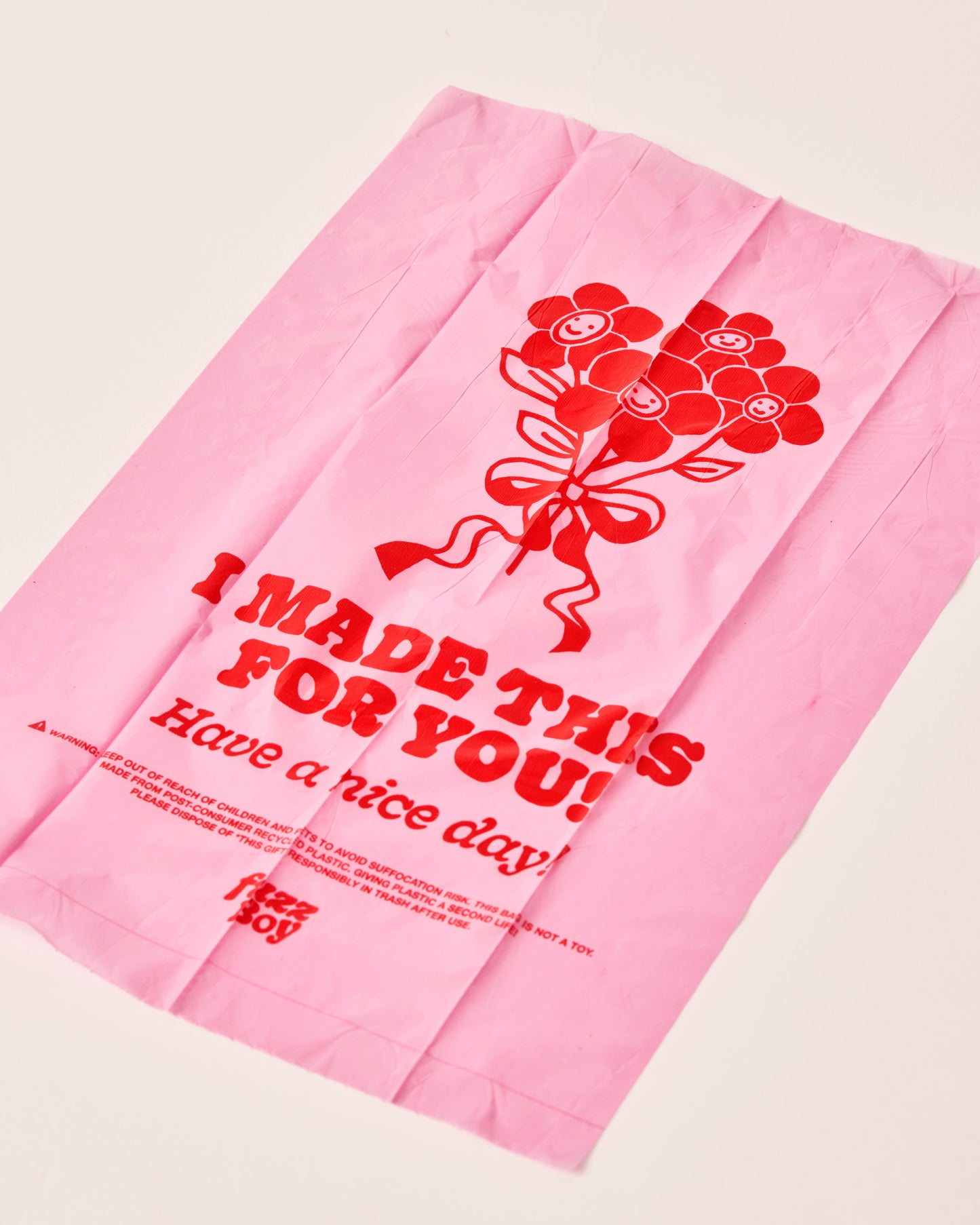 Pink bag with red illustration and text. The graphic is a bouquet of flowers. The text reads 'I made this for you! Have a nice day!'