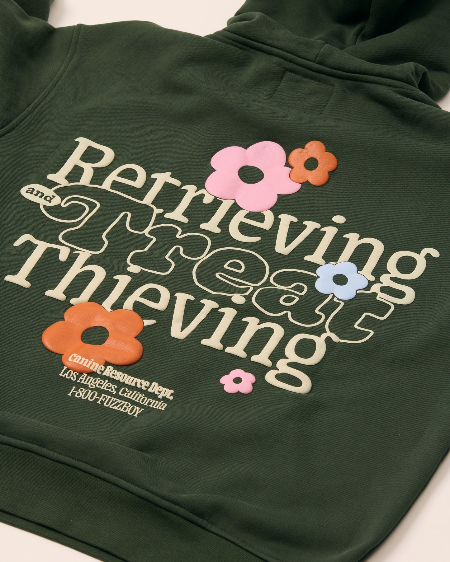 Forest green hoodie with puff printed text and floral designs.