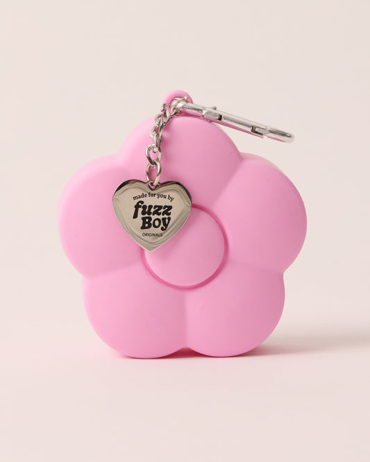 Pink flower-shaped treat pouch attached to a silver keychain, along with a heart-shaped charm embossed with the text 'Made for you by Fuzzboy Originals'
