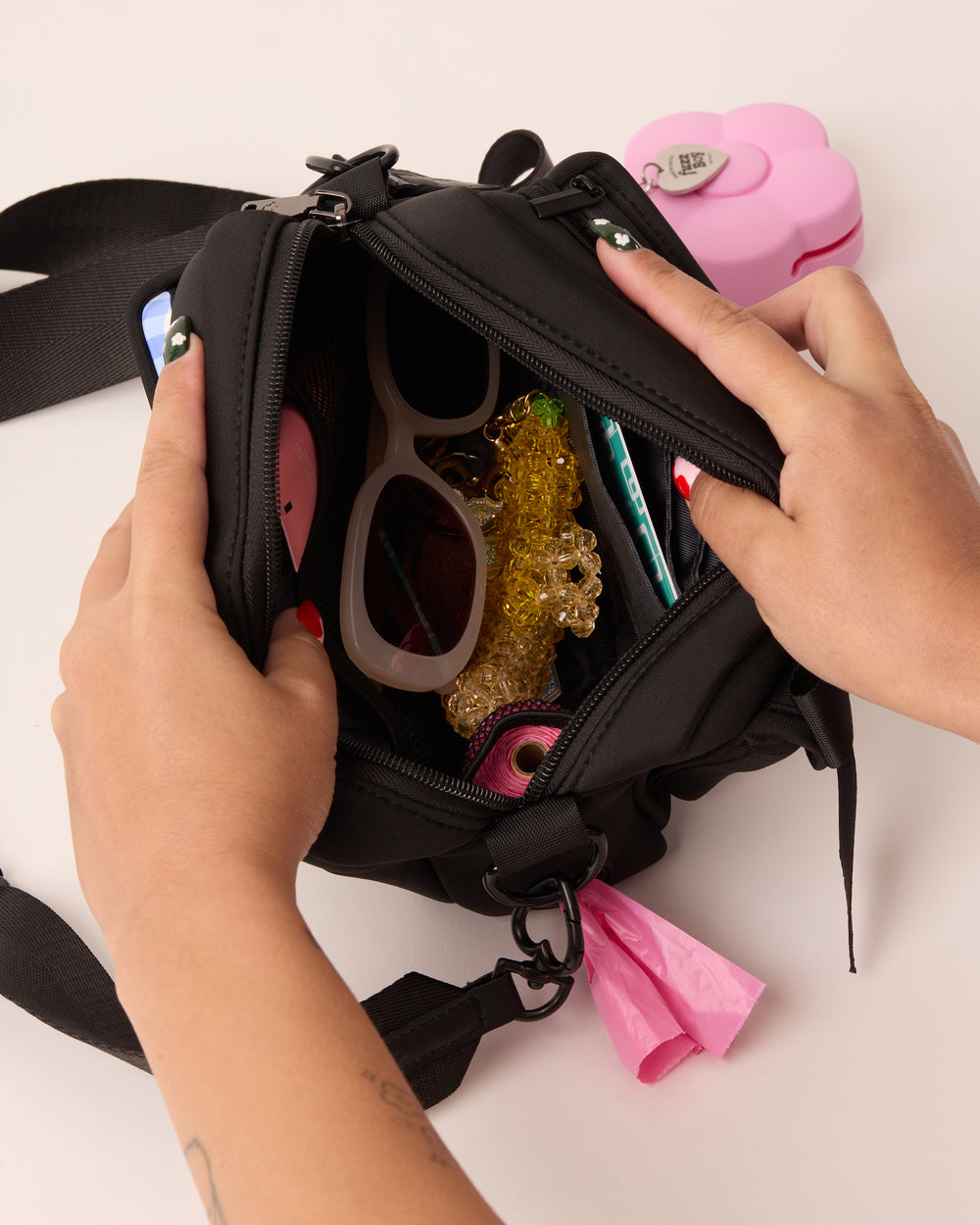 Top down view of a person holding the black walking bag open. This is to demonstrate how much the interior pocket can hold.
