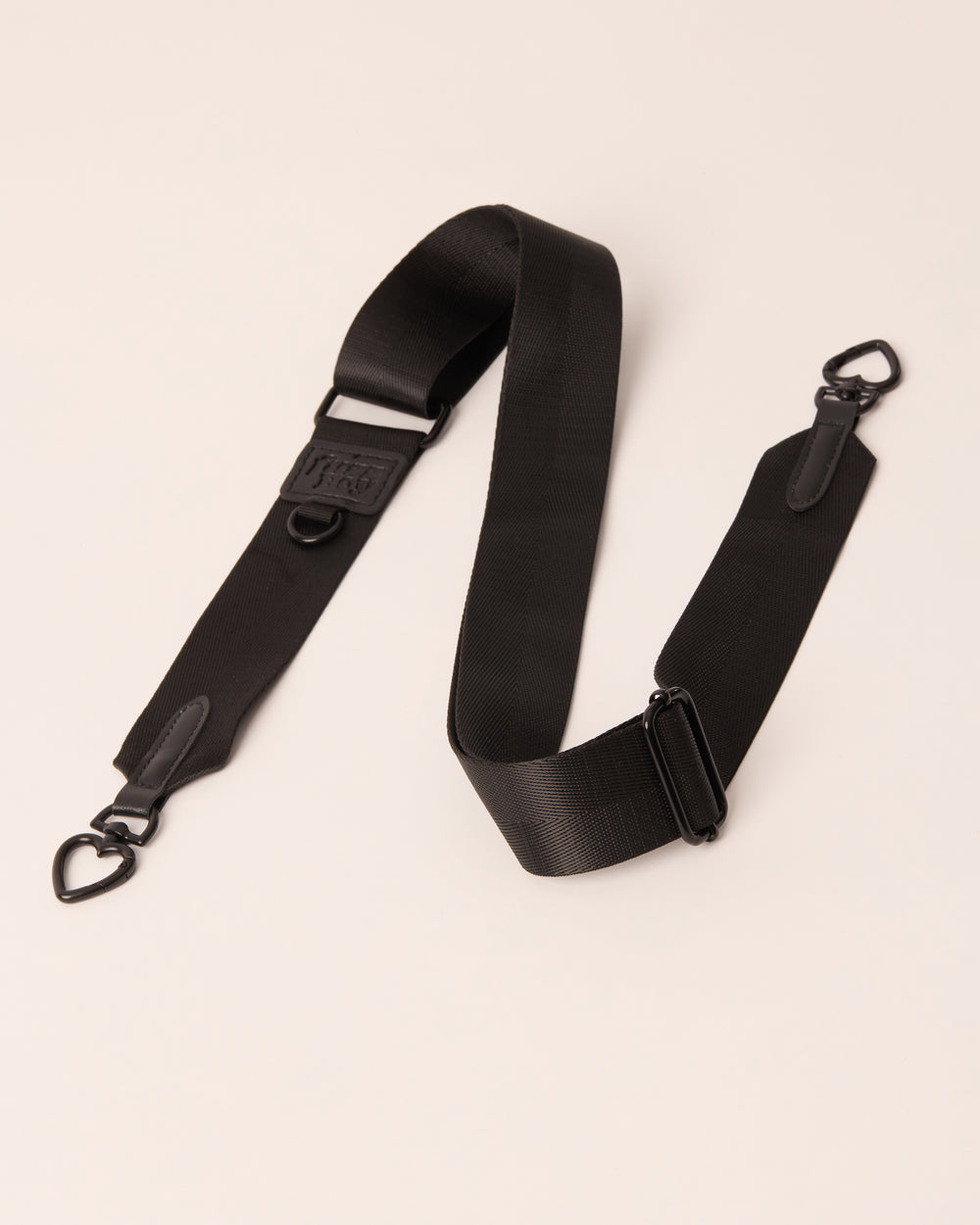 Black detachable and adjustable strap with black hardware. 