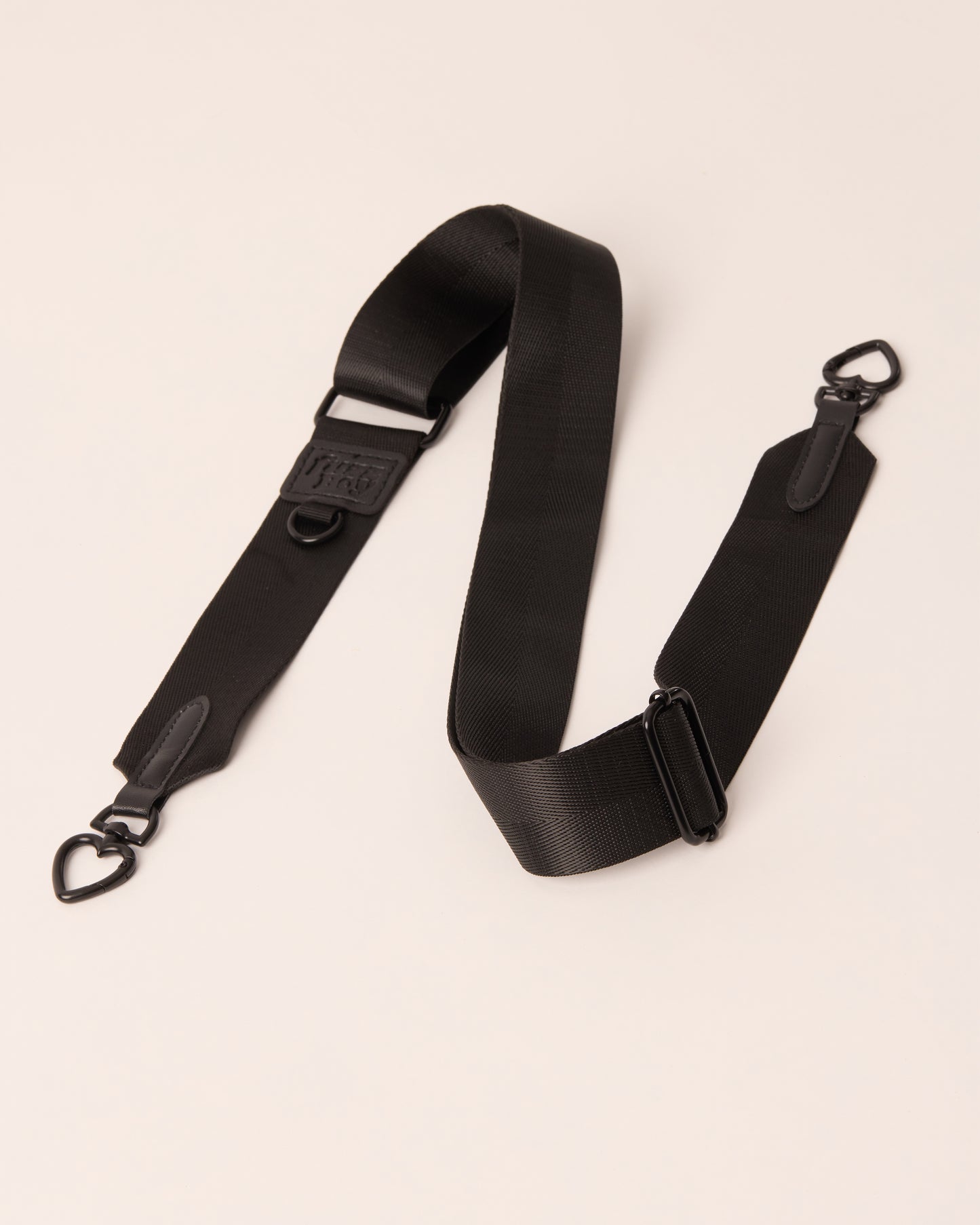 Black detachable and adjustable strap with black hardware. 