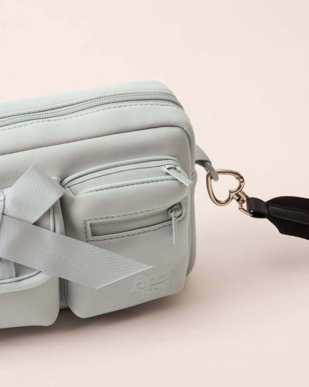 Detail of the light blue walking bag and the heart-shaped hardware from the detachable strap. 