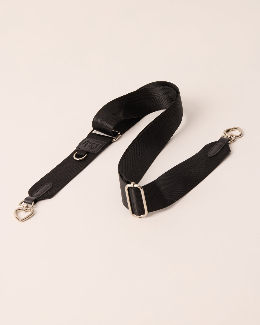 Black detachable and adjustable strap with silver hardware. 